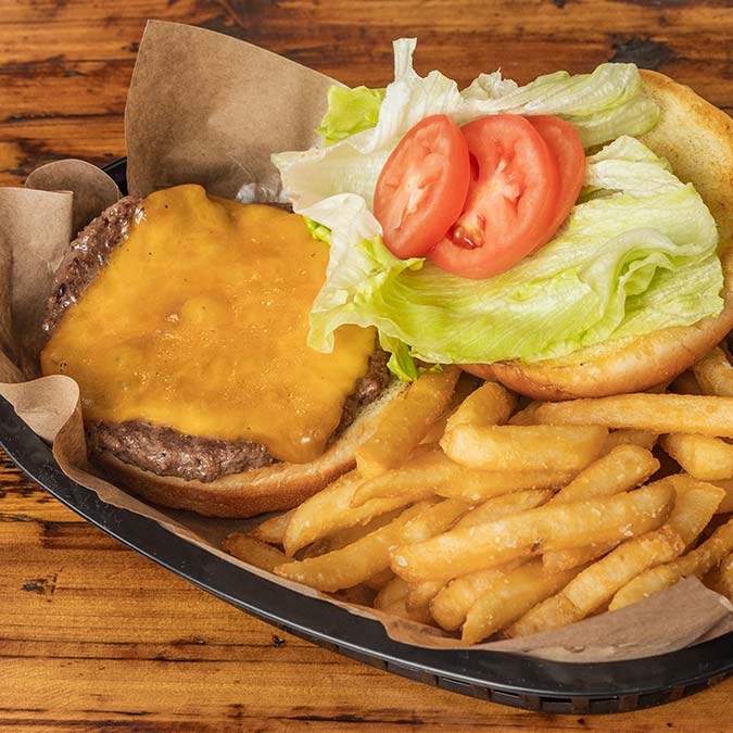Open cheeseburger with lettuce and tomato, served with fries at our BBQ restaurant in Mundelein IL.