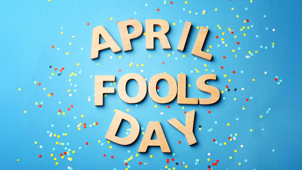 Wooden letters spell April Fools Day Specials Mundelein on blue, with colorful confetti scattered.