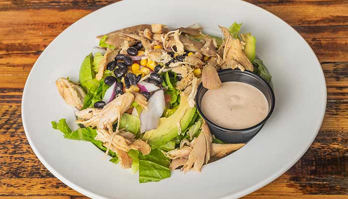 Salad with shredded chicken, avocado, black beans, and more—perfect for a BBQ menu in Mundelein IL.